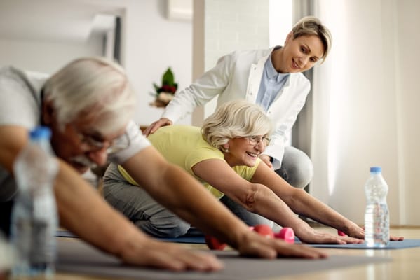 Residents participating in a gentle stretching exercise class