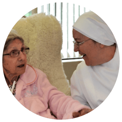 A caregiver interacting with a resident in a cozy setting