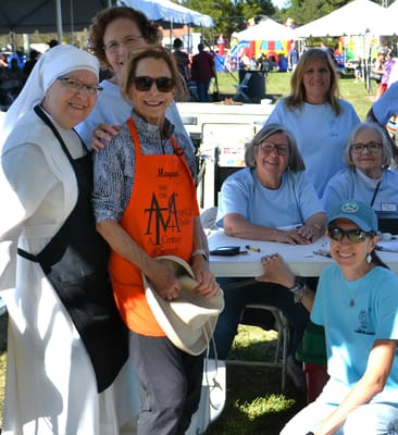 Group of staff and volunteers at an outdoor event
