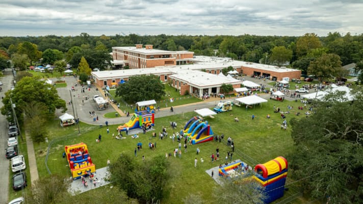 Aerial view of a festive outdoor event at a senior living facility