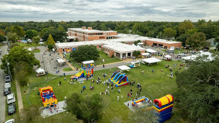 Aerial view of a festive outdoor event at a senior living facility