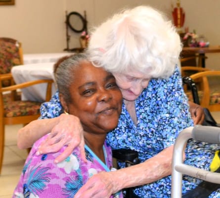 Two residents sharing an affectionate moment in the common area