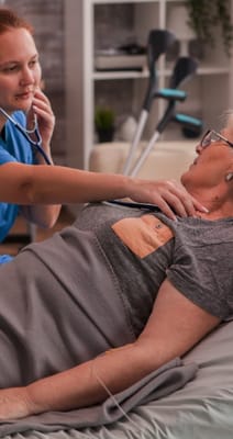 Healthcare professional assisting a senior resident