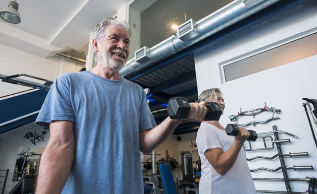 Seniors exercising with dumbbells in a gym
