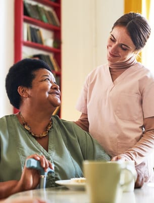 A caregiver interacting with a resident in a warm setting