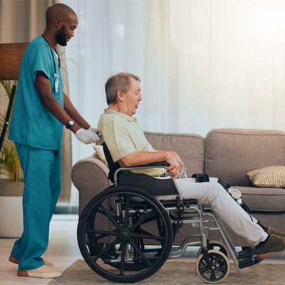 A caregiver assisting a resident in a wheelchair