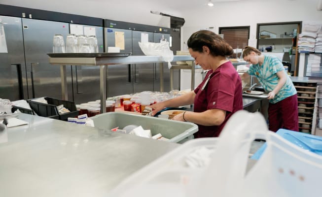 Staff preparing meals in a kitchen area