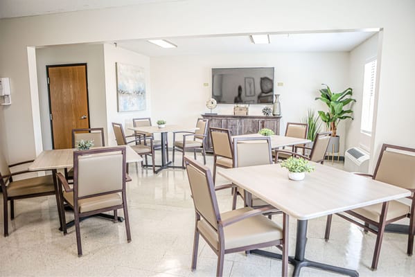 Bright common area with tables and chairs