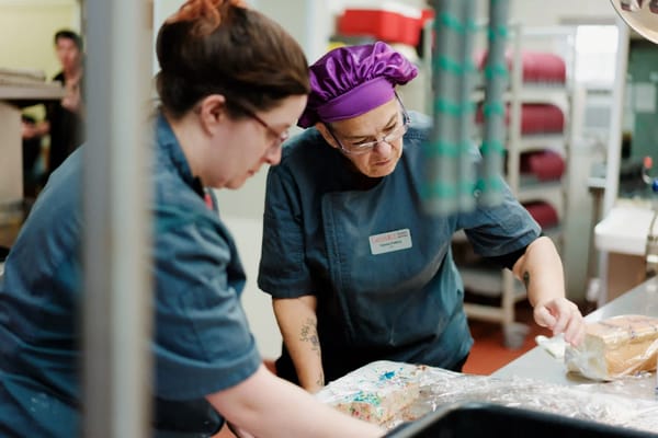 Staff preparing food in a kitchen setting