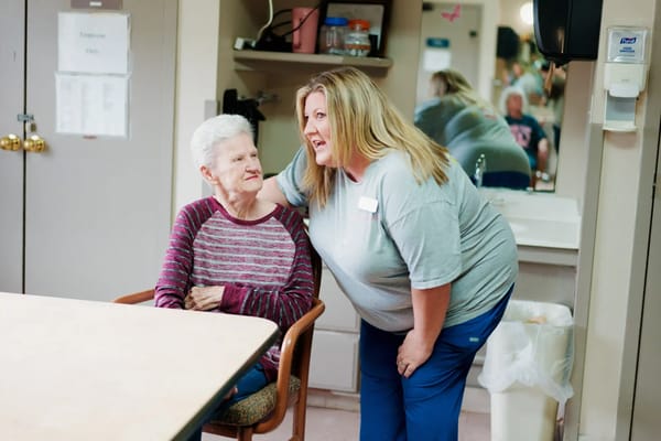 Staff member interacting with a resident in a cozy room