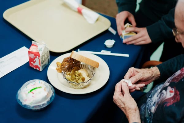 Residents enjoying a meal with dessert