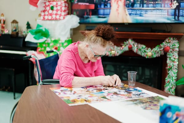 A resident working on a puzzle during an activity