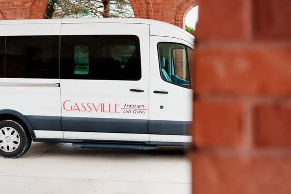 Facility transport van parked at the entrance