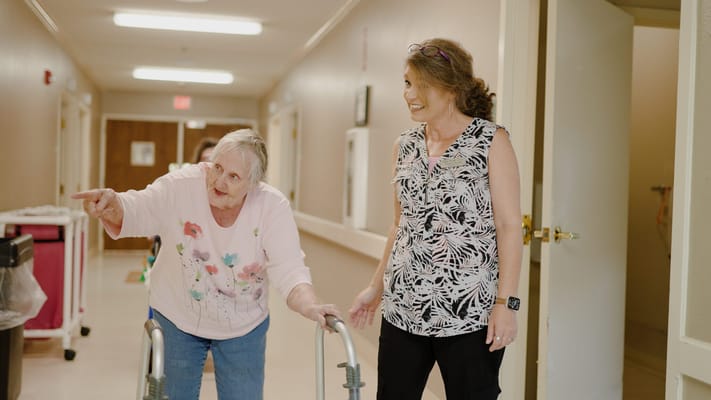 Residents interacting in a hallway of a facility