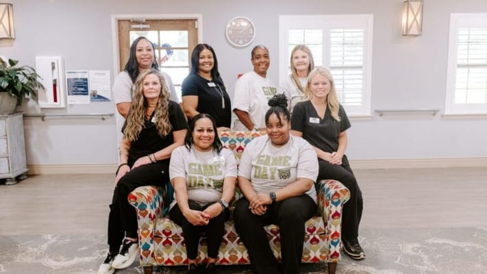 Staff members posing in a care facility's common area
