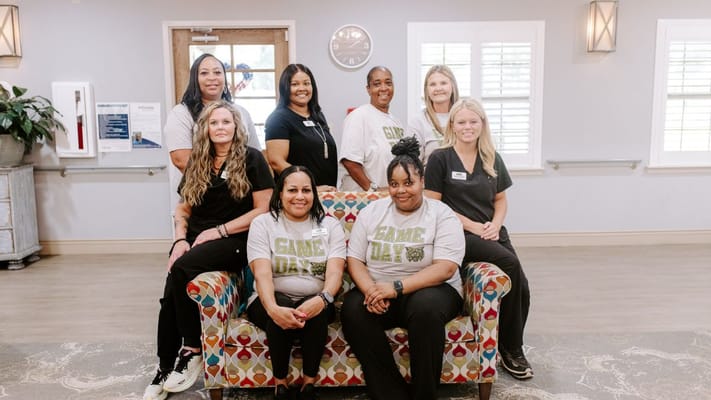 Staff members posing in a care facility's common area