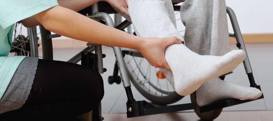 Care staff assisting a resident in a wheelchair