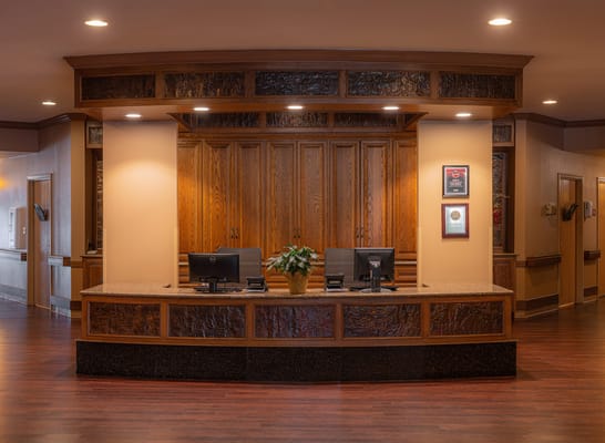 Reception area with a warm wooden design and seating