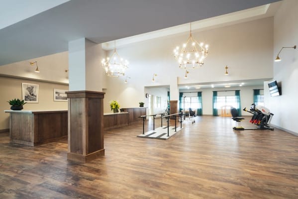 Bright common area with fitness equipment and seating