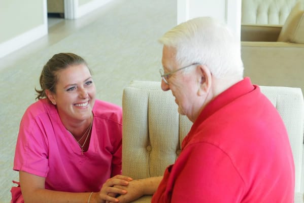 Caregiver interacting with a resident in a facility