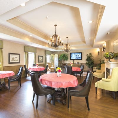 Bright dining room with round tables and floral centerpieces