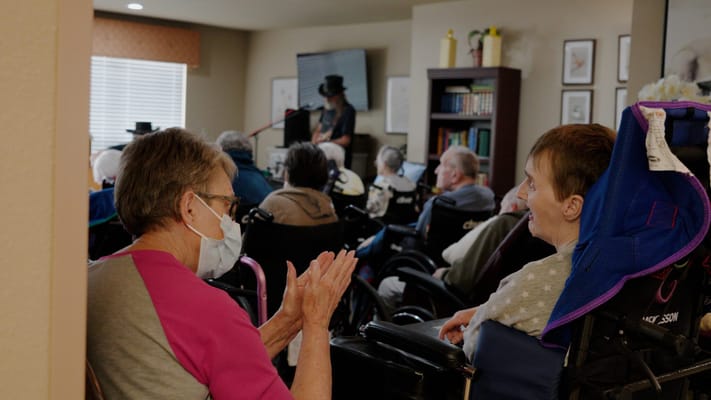 Residents enjoying a musical performance in a common area