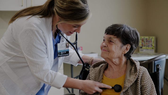 Nurse attending to a resident in a care facility