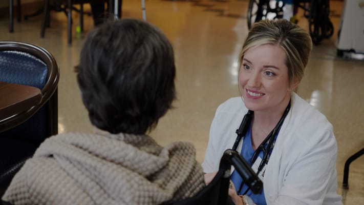 Nurse interacting with a resident in a common area