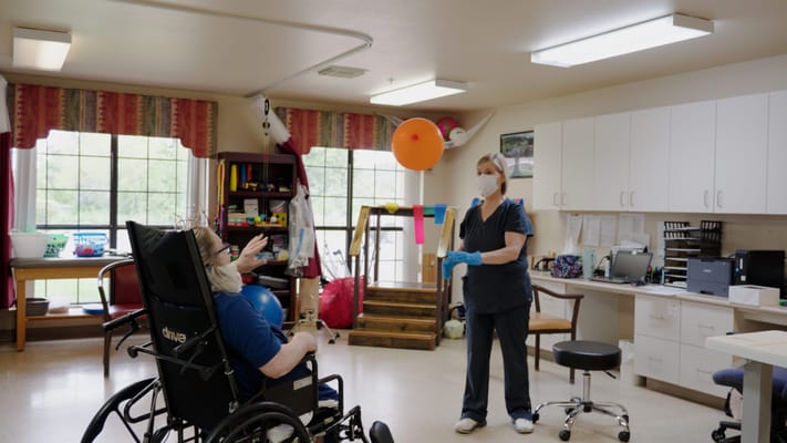 Residents engaging in a therapeutic activity in a bright room