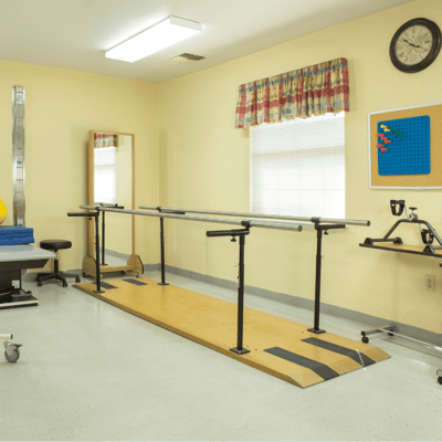 Rehabilitation space with parallel bars and therapy equipment
