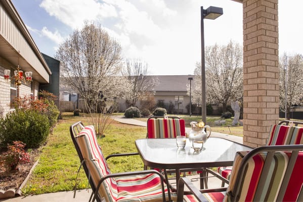 Outdoor patio area with seating and flowers