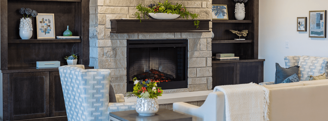 Warm common area with a cozy fireplace and seating