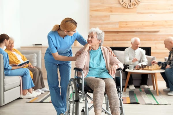 Caregiver assisting a resident in a common area