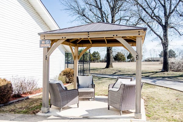 Outdoor seating area with gazebo and chairs