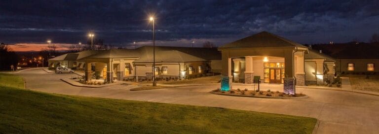 Exterior view of a senior living facility at dusk