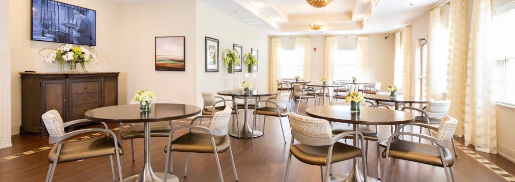 Bright dining area with tables and floral decorations