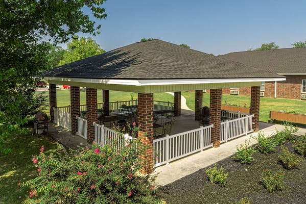 Covered outdoor space with seating and greenery