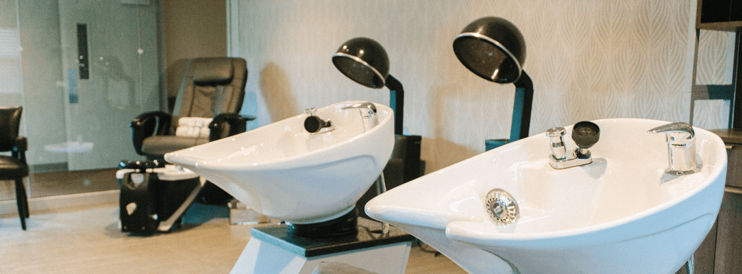 Hair salon area with wash stations and chairs