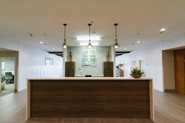 Bright reception area with wooden front desk