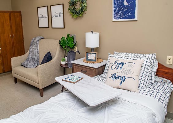 Cozy private room featuring a bed and seating area