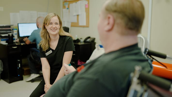 Staff member engaging with a resident in a facility