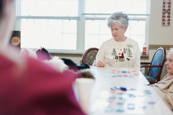 Residents engaged in a bingo activity in an activity room