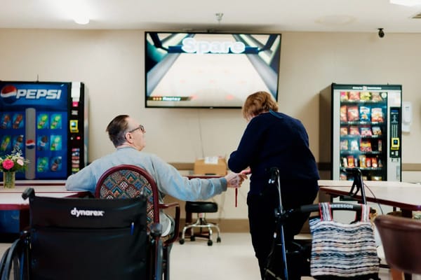 Residents enjoying a bowling game in a social area