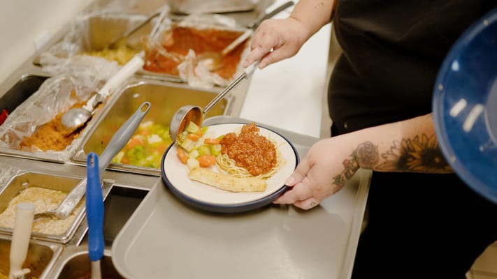 Staff serving delicious meals in the dining area