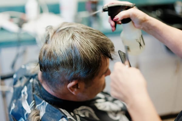 Hair stylist cutting a resident's hair