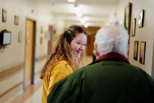 Staff member engaging with a resident in a hallway