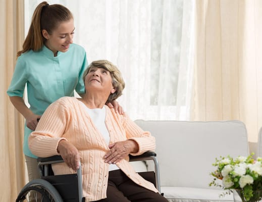 Caregiver assisting a resident in a bright room