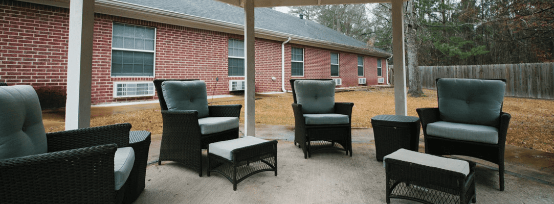 Outdoor seating area with chairs under a shelter