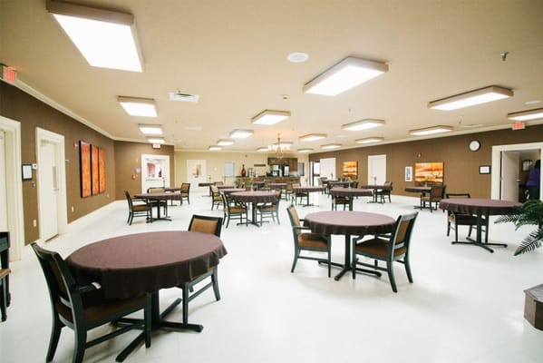 Spacious dining room with circular tables and chairs