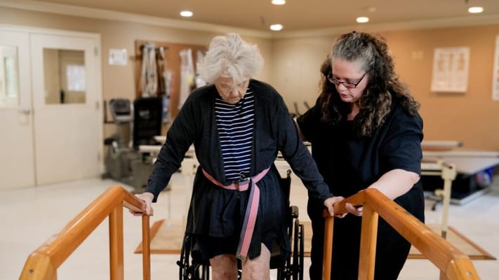 A staff member assisting a resident in therapy